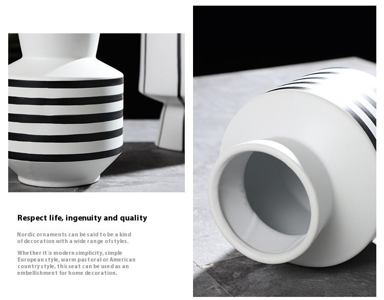 Black and white striped ceramic vase with a light, modern design suitable for contemporary home decor.