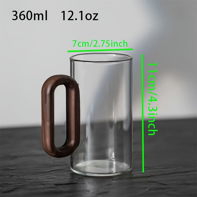 Clear glass mug with wooden handle and measurements on a gray background
