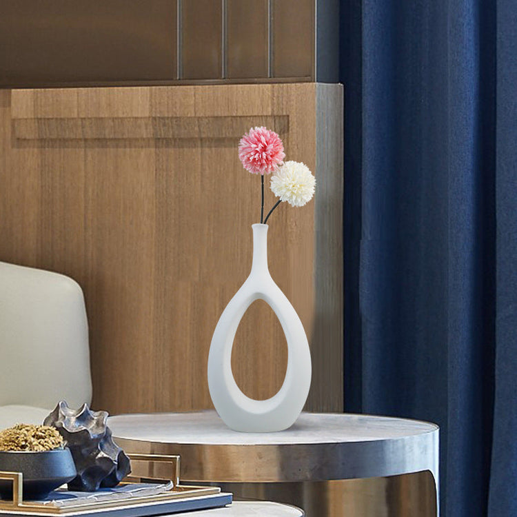 Elegant ceramic vase with a unique shape, featuring floral arrangement for modern home decor by FLIPSTYLEZLLC.