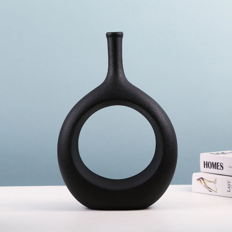Elegant ceramic vase with a unique shape holding flower arrangement, modern luxury home decor from FLIPSTYLEZLLC.