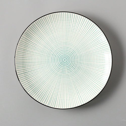 Round decorative plate with a geometric pattern on a gray background