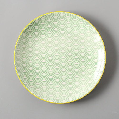 Decorative plate with green wave pattern on a gray background