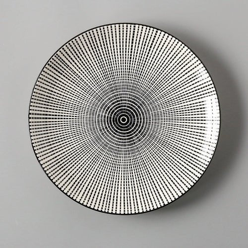 Round decorative plate with concentric circle pattern on a gray background