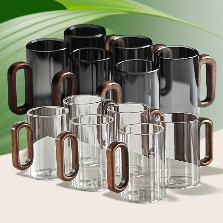 Set of glass mugs with wooden handles on a reflective surface with a green background