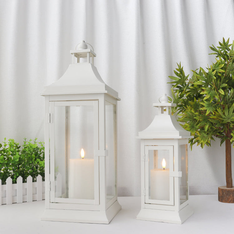 Set of two JHY DESIGN outdoor decorative candle lanterns, 19.5 and 13 inches tall with glass panels and metal frames.