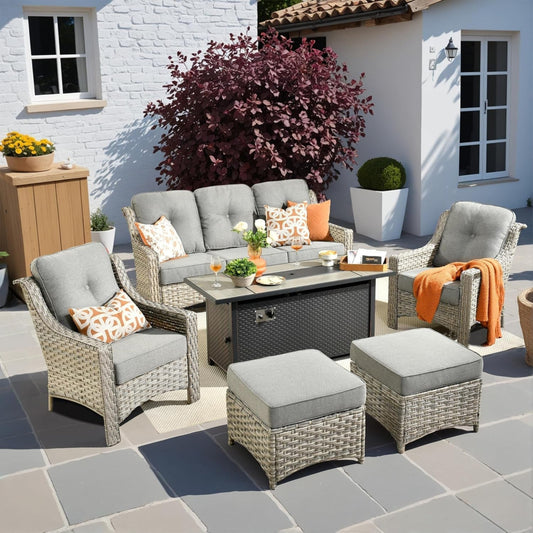 Outdoor patio set with furniture and decor in front of a white building.