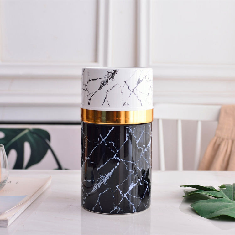 Modern marbled golden ceramic vase with sleek, simple design, featuring a smooth surface and elegant aesthetic.