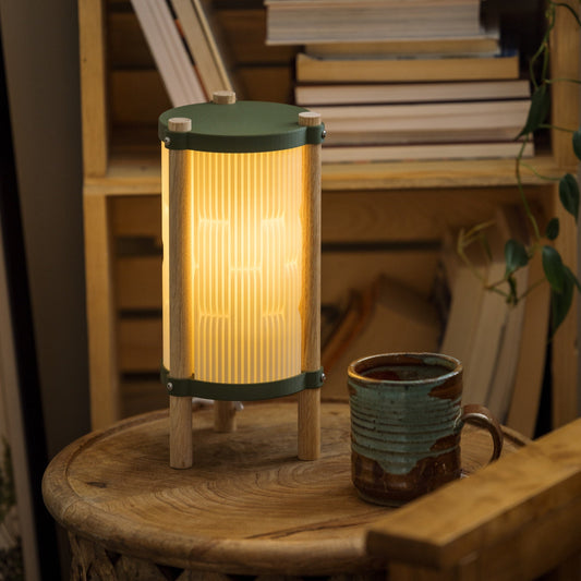 Terra Labs Toro table lamp with a sleek modern design and a cylindrical white lampshade on a wooden base.