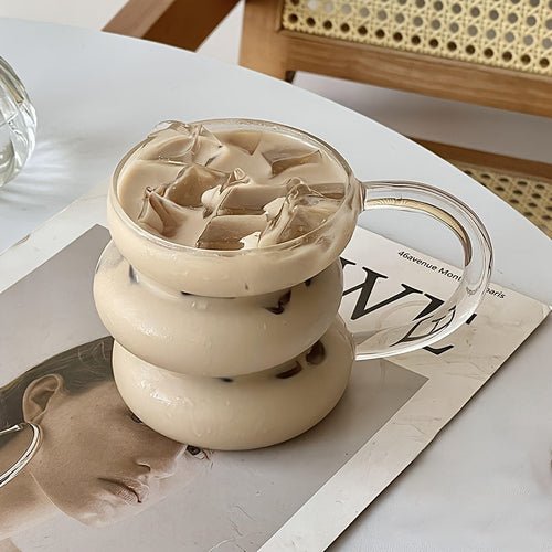 Glass teapot with layered design on a magazine