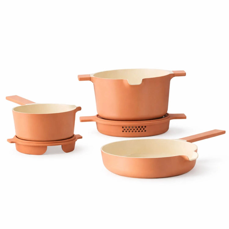 Alva Cookware 5-piece nesting set of mixing bowls with lids in various sizes stacked together for space-saving storage.