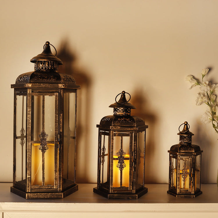 Set of 3 large outdoor metal and glass candle lanterns for patio decor, featuring decorative design and candle holders.