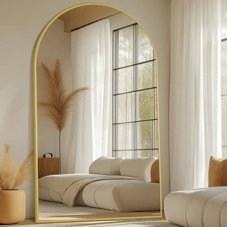 Full-length freestanding arched floor mirror with gold aluminum frame by MIRRORONS, showcasing its curved design and reflective surface.