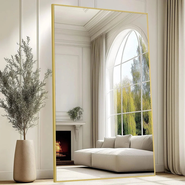 Oversized freestanding arched floor mirror with full-length gold aluminum frame, showcasing a sleek, modern design.