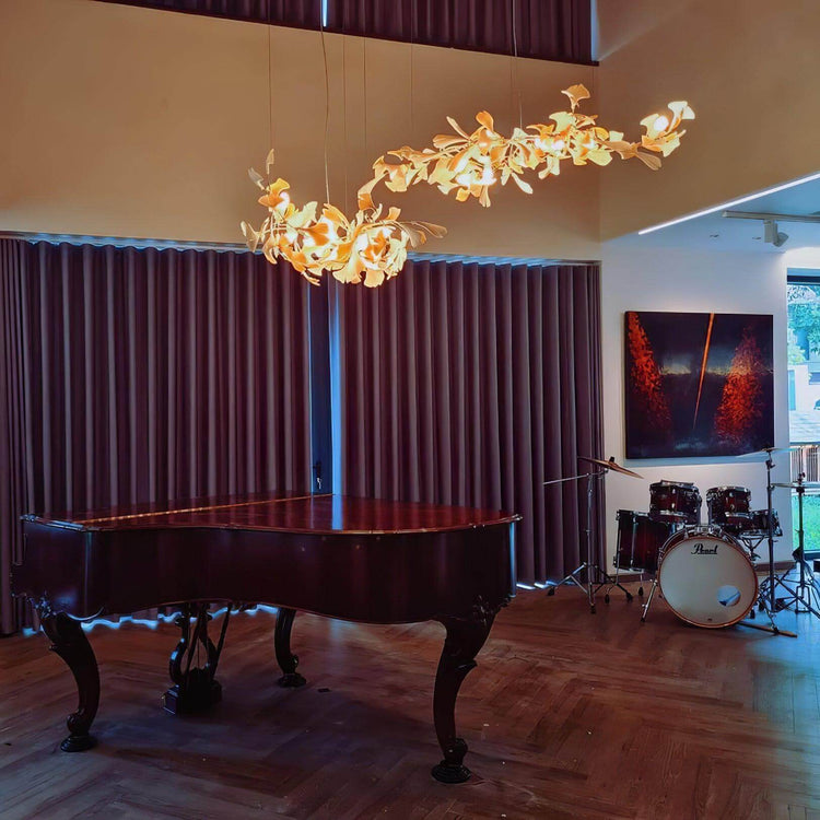 Vinlighting Gingko Chandelier Style H, an art deco linear chandelier with leaf-inspired design, hangs with elegant gold accents.