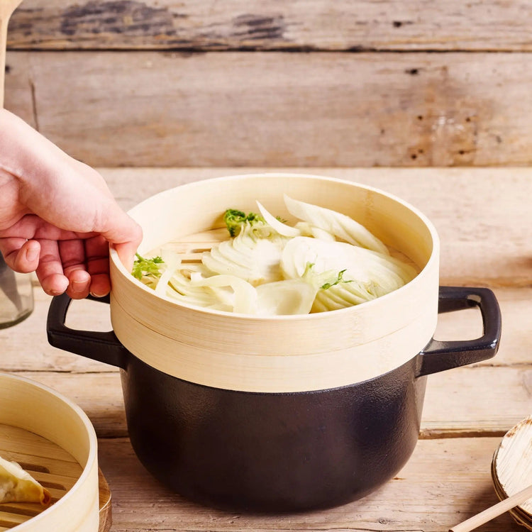 Alva Cookware 2.5 qt Dutch oven with steamer inserts, durable cast iron design for versatile cooking and steaming.