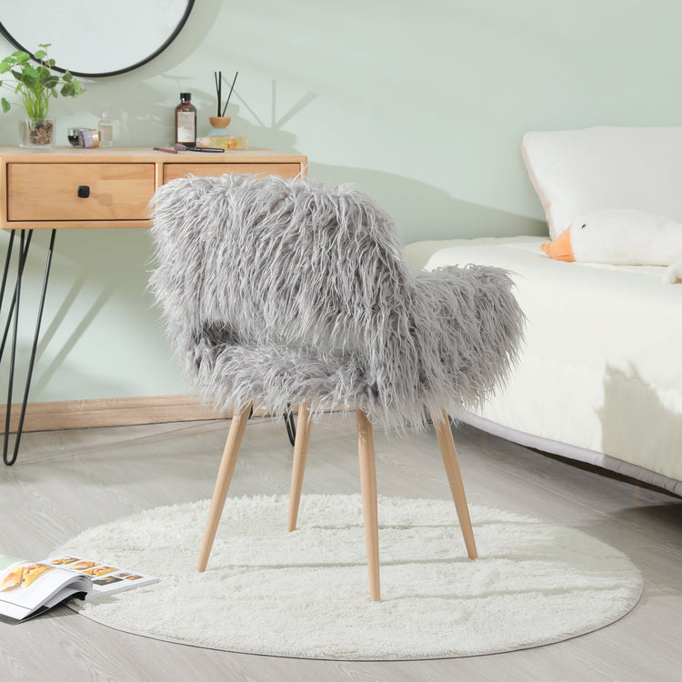 Grey faux fur upholstered dining chair with metal legs, modern design, comfortable seating for dining rooms.