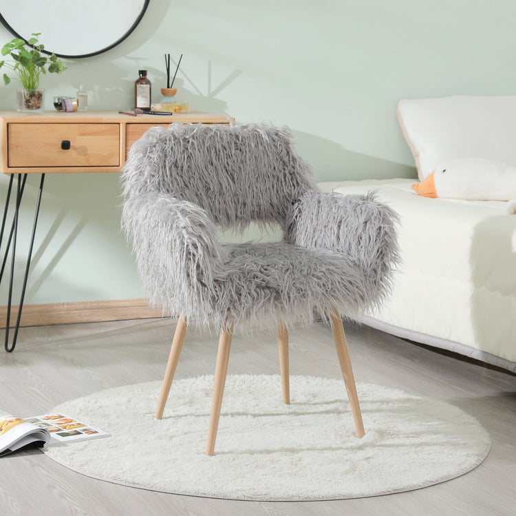 Grey faux fur upholstered dining chair with metal legs, modern design and plush seating for dining and living spaces.