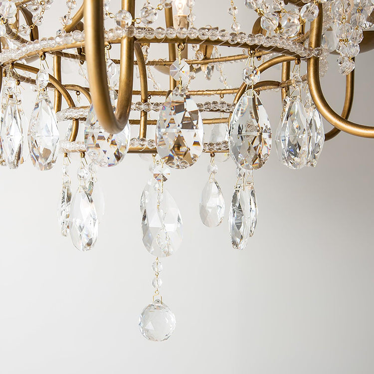 Early American-style Mooiehome chandelier measuring 25.2 inches with vintage brass finish and multiple candle-style lights.