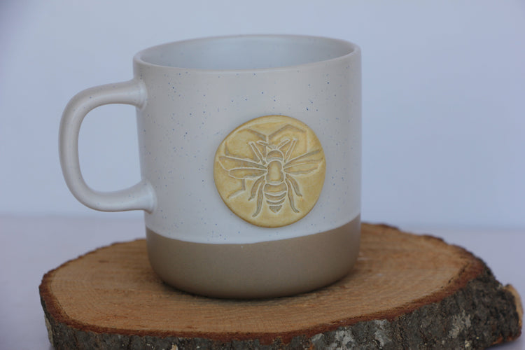Ceramic bee-shaped mug with detailed honeybee design, handcrafted by Prodigal Pottery, on a neutral background.