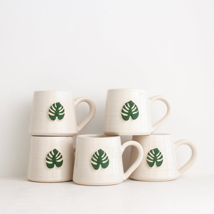 Black Oak Art Monstera Mug featuring a vibrant monstera leaf design, perfect for plant lovers and coffee enthusiasts.