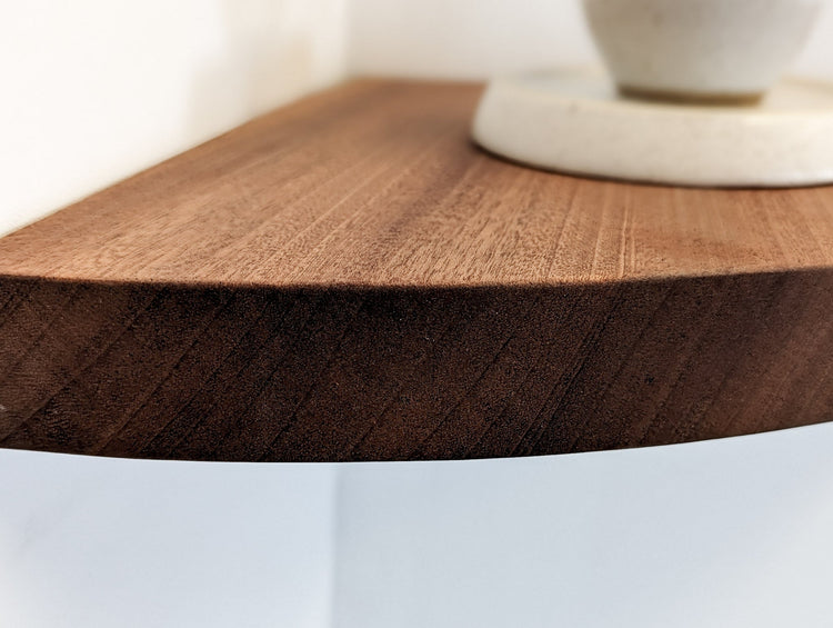Handmade mahogany corner wall shelf from NookWoodworking, floating storage shelf mounted in a modern living space.