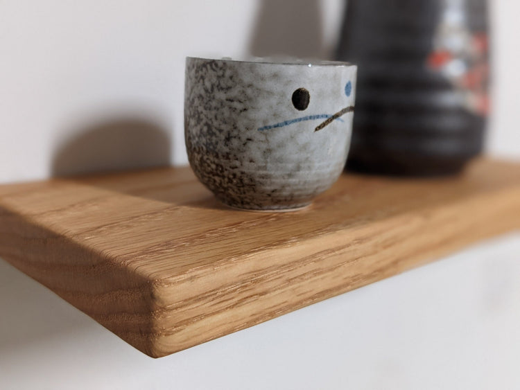 Natural oak floating wall shelf by NookWoodworking, 6 to 36 inches, minimal design for stylish wall storage or display.