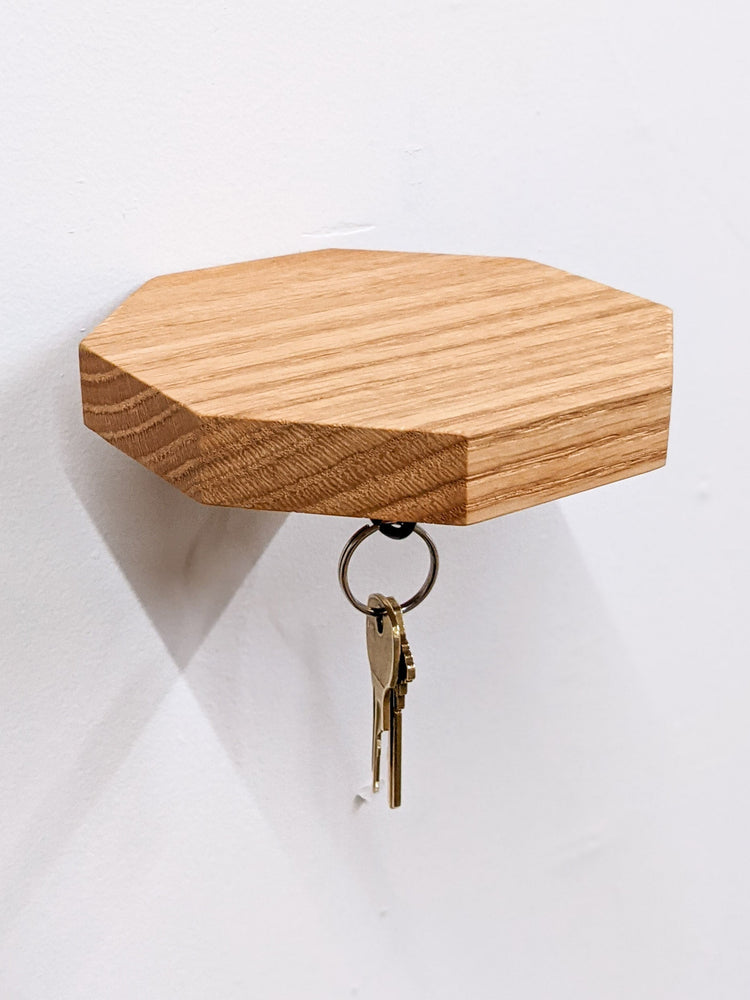 Wooden octagon key hook shelf in oak, NookWoodworking entryway wall shelf with hooks for keys and small accessories.