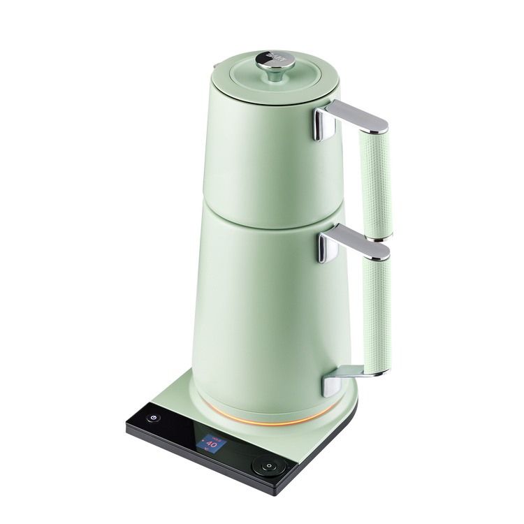 Saki Turkish Tea Maker Pro in sage green with glass pot and stainless steel handle for brewing traditional Turkish tea.