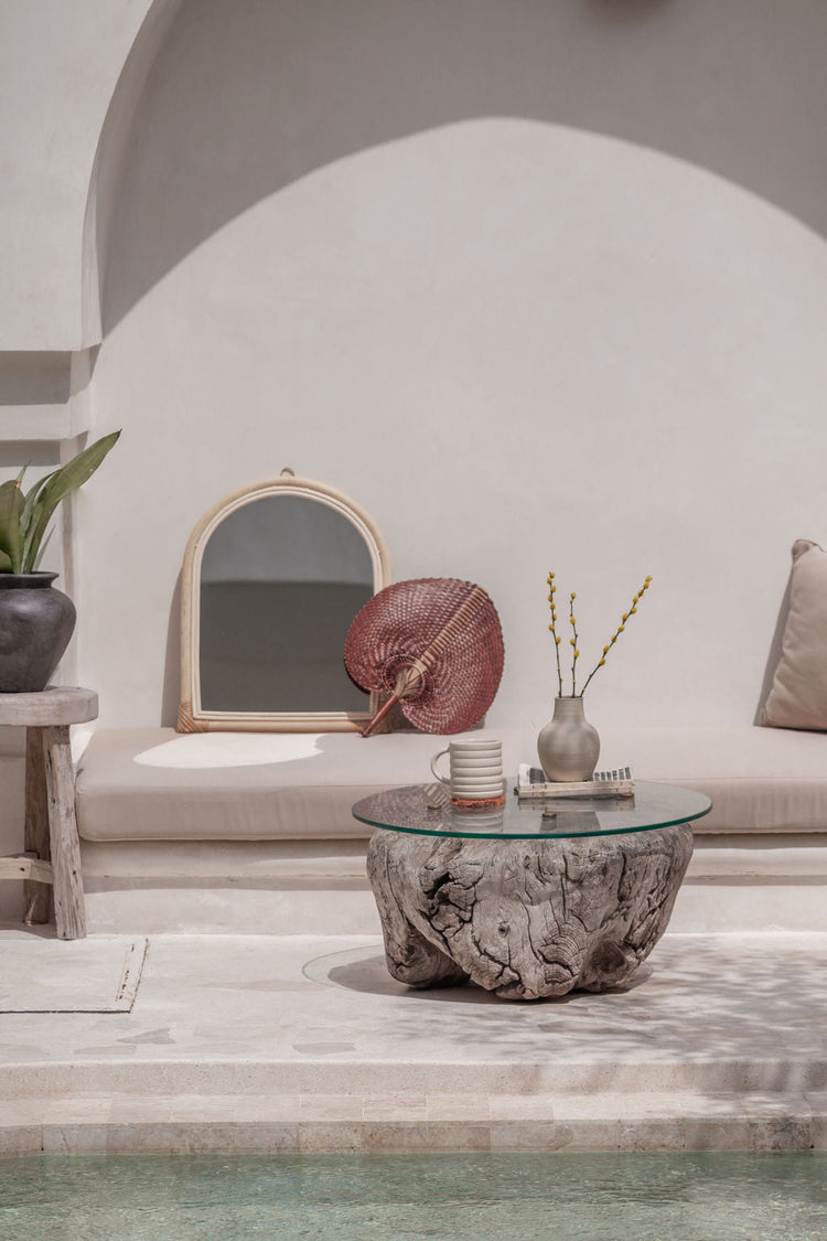 Handmade arch rattan wall mirror with natural boho design by Village Thrive, showcasing a stylish, woven rattan frame.