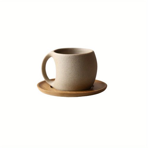 Ceramic mug with wooden saucer on a white background