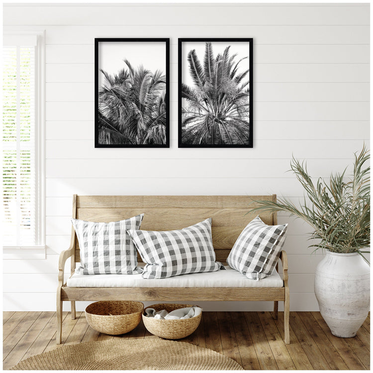 A set of two framed wall art pieces featuring palm tree illustrations by kateandlaurel, perfect for modern home decor.