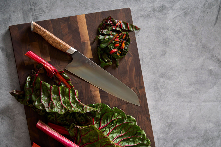 Steelport Knife Co. everyday knife and cutting board set shown in use on a kitchen countertop with food preparations.