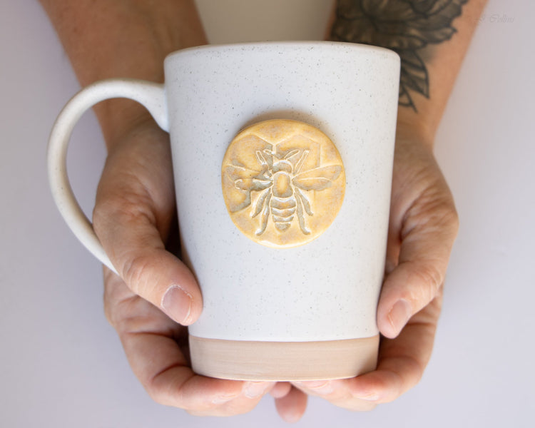 Ceramic bee-shaped mug with detailed yellow and black bee design, perfect for coffee or tea, by prodigalpottery.