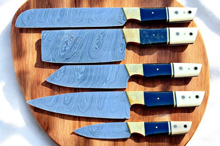 Premium handmade Damascus kitchen knives set with resin and bone handles, showcasing sharp blades and intricate patterns.