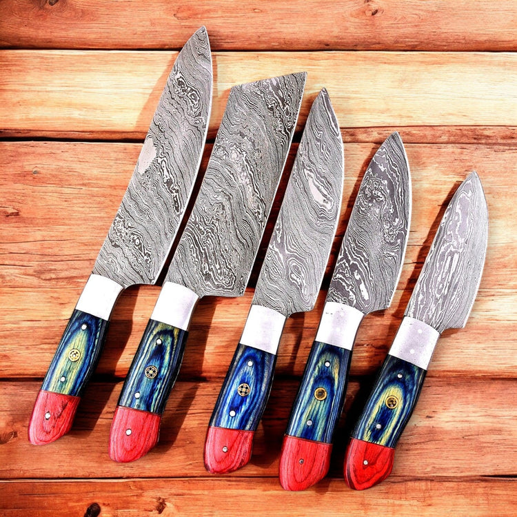 Handmade Damascus Steel kitchen knife set with exotic wood handles, featuring multiple knives displayed on a wooden surface.