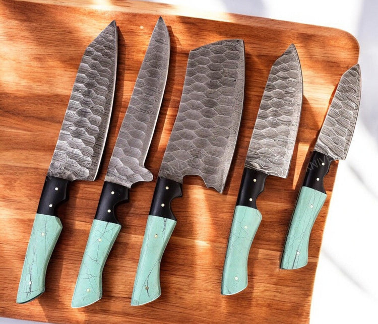 Handmade Damascus kitchen knives set with epoxy resin handles, featuring intricate blade patterns and ergonomic design.