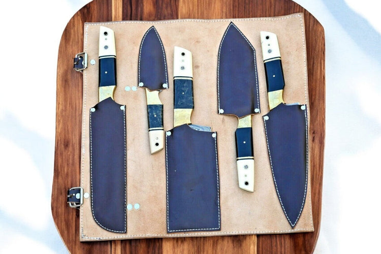 Premium handmade Damascus kitchen knives set with resin and bone handles, featuring sharp blades and intricate design details.