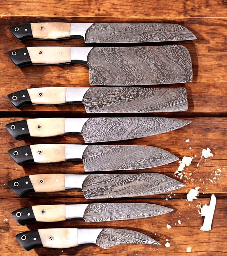Set of premium Damascus kitchen knives from Damascus Knife Store, featuring handmade, sharply crafted blades with wooden handles.