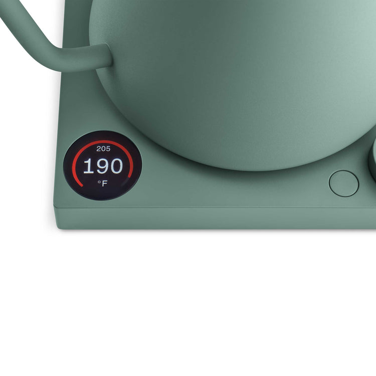Fellow Stagg EKG Pro electric kettle in smoke green with maple handle, featuring a sleek design and digital temperature control.