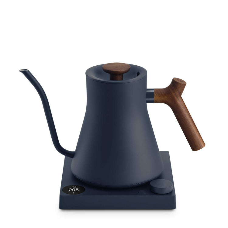 Fellow Stagg EKG Pro electric kettle in stone blue with walnut accents, showcasing its sleek design and control panel.