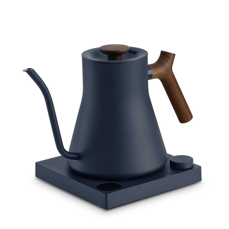 Fellow Stagg EKG Pro electric kettle in stone blue with walnut handle, featuring sleek design and digital temperature control.