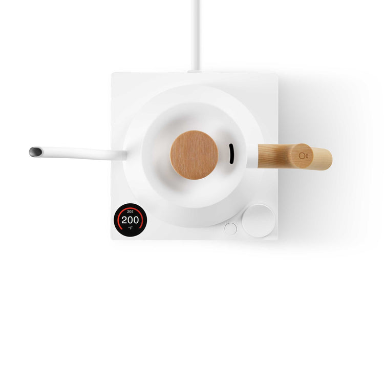 Fellow Stagg EKG Pro electric kettle in matte white with maple wood handle, featuring a sleek design and digital temperature control.