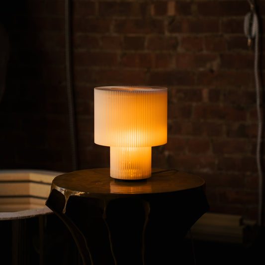 Wooj Design drum lamp with a round, fabric shade and modern design, ideal for contemporary home lighting.