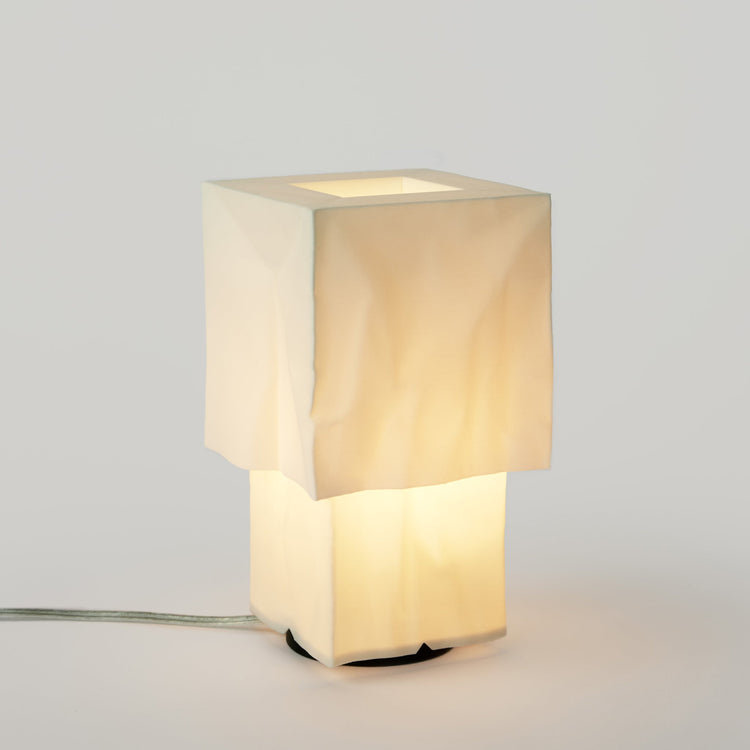 Modern Farolito Lamp by Wooj Design featuring warm ambient lighting and a sleek accent table lamp design.