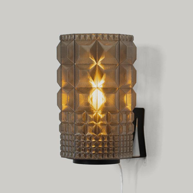 Wooj Design Gem Sconce with geometric glass shade and brass finish mounted on a wall.