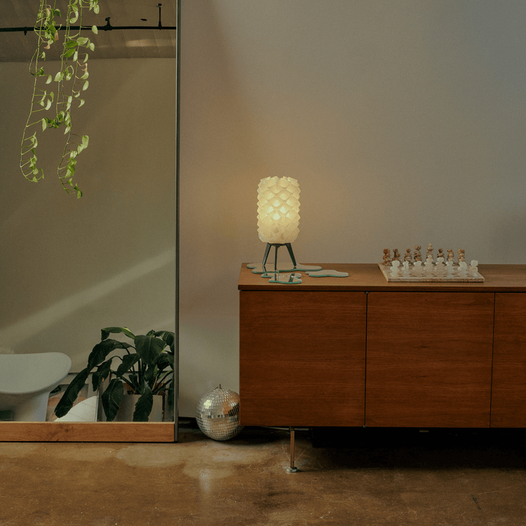 Matte black Lotus lamp by Wooj Design, contemporary designer lighting with a sleek, modern aesthetic.