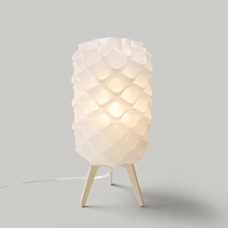 Matte black Lotus lamp by Wooj Design, contemporary designer lighting with a sleek, modern floral-inspired lamp shape.