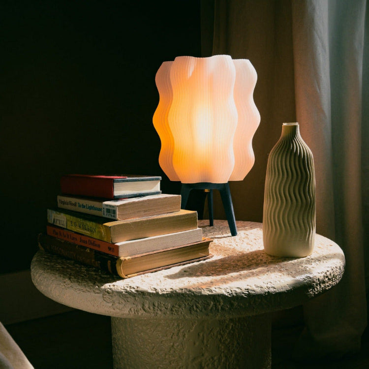 Matte black Wavy Lamp by Wooj Design, a 3D printed sculptural table lamp with a wavy, organic shape and modern aesthetic.