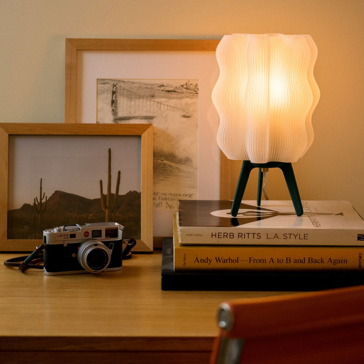 Matte black 3D printed Wavy Lamp by Wooj Design, sculptural table lamp with a modern, wavy design and sustainable AI-inspired lighting.