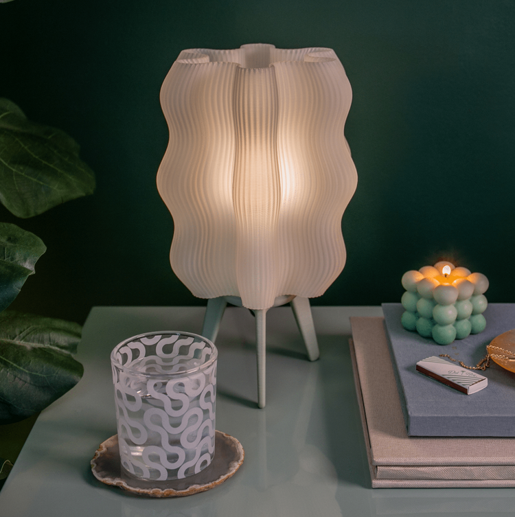Matte black 3D printed Wavy Lamp by Wooj Design, a sculptural table lamp with a flowing, wave-like design for modern lighting.